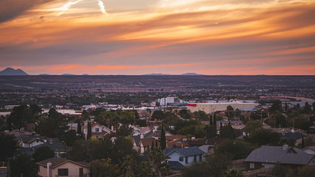 Sunset view over rooftops and mountains in a small Arizona town.
