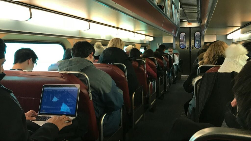 Person using laptop on train