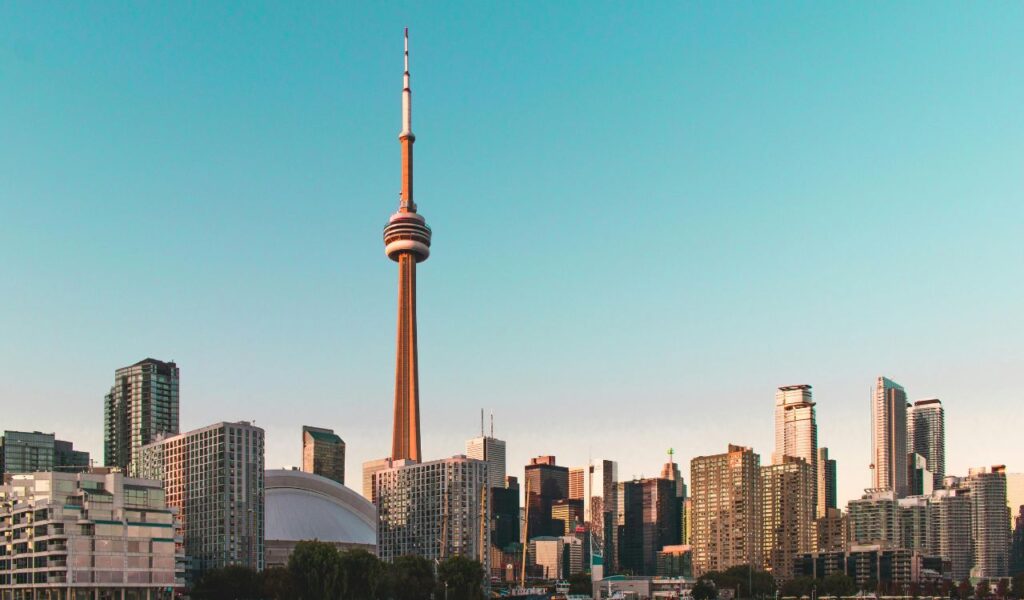 Toronto skyline with CN Tower at sunset, iconic view of downtown Canada cityscape.