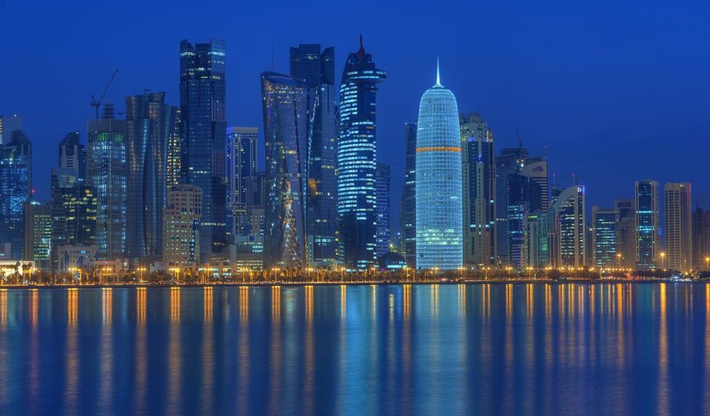 Doha, Qatar: A futuristic skyline blending traditional culture with modern architecture, driven by rapid growth and global events.