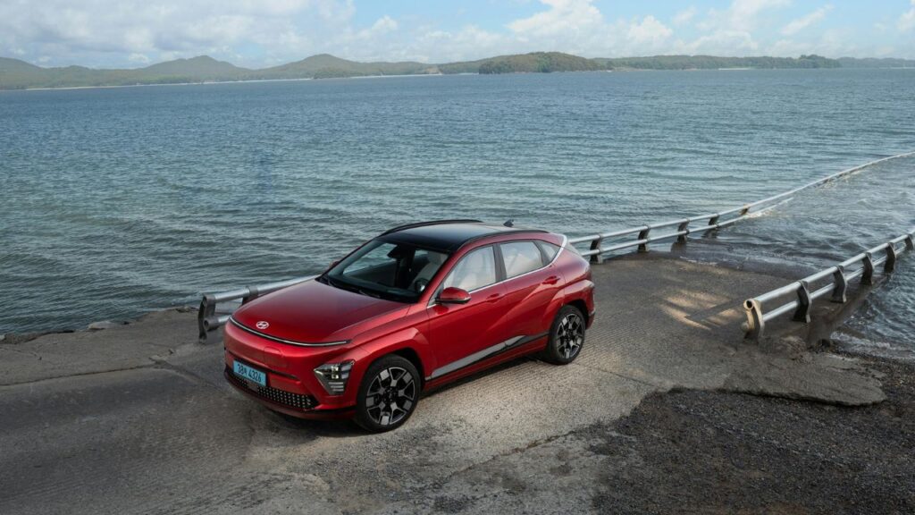 Electric Red Hyundai Kona on Seashore
