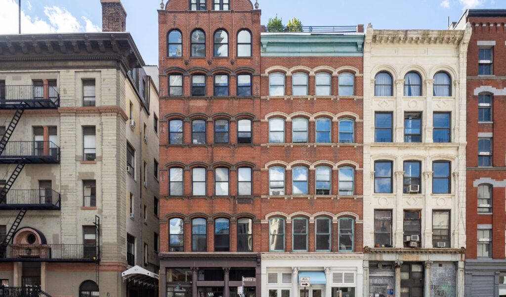 Red-brick loft building in Brooklyn, New York, with arched windows and historic facade, near the Firehouse Loft rental.