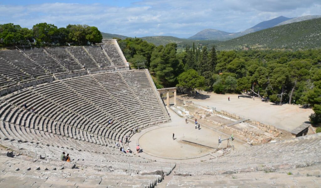 Ancient Theater of Epidaurus surrounded by forested hills in Greece