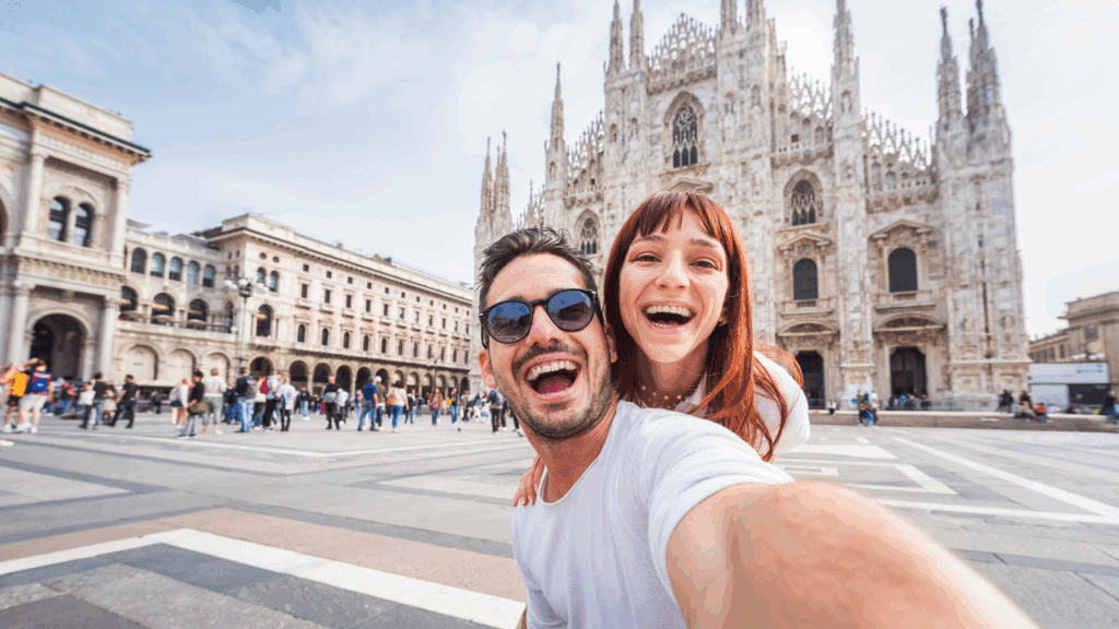 Happy-couple-taking-selfie-in-front-of-Duomo-cathedral-in-Milan-Lombardia