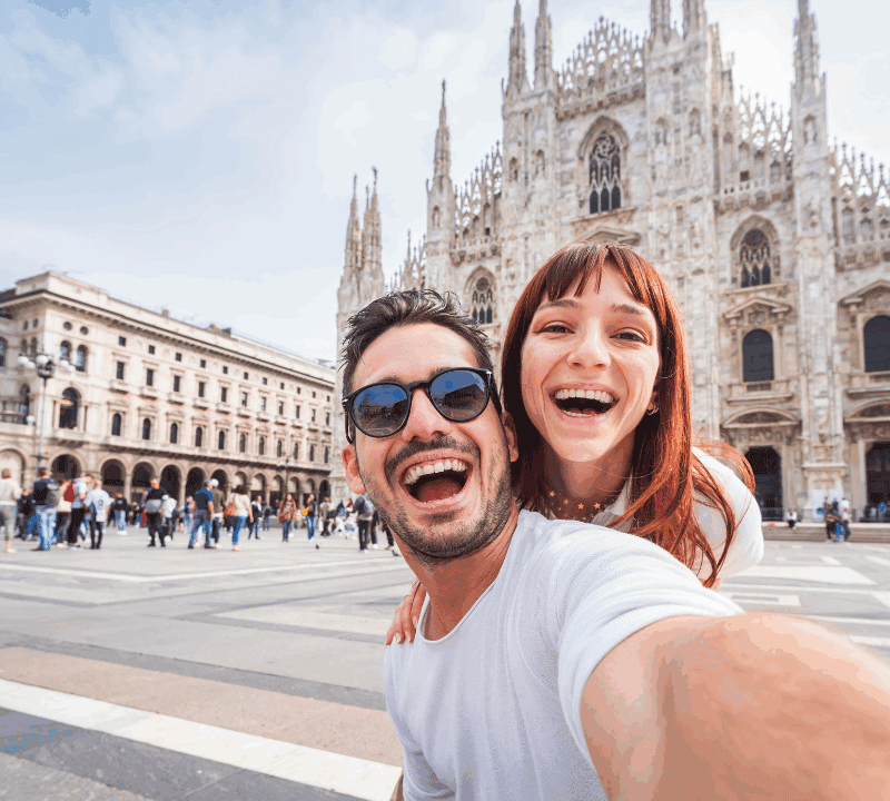 Happy-couple-taking-selfie-in-front-of-Duomo-cathedral-in-Milan-Lombardia