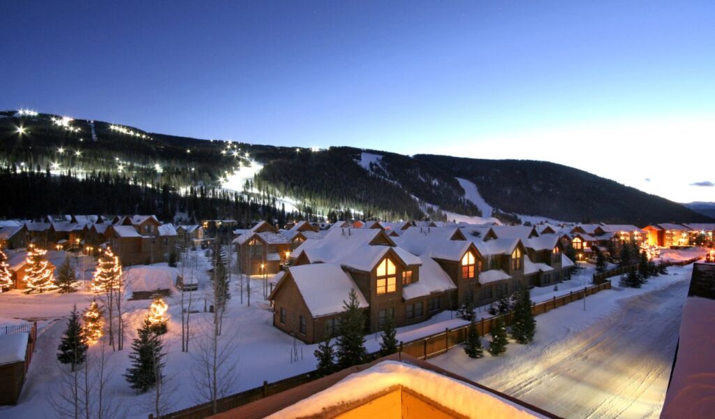 Twinkling lights on snowy slopes and cozy cabins below—Keystone, Colorado glowing under a crisp winter night.