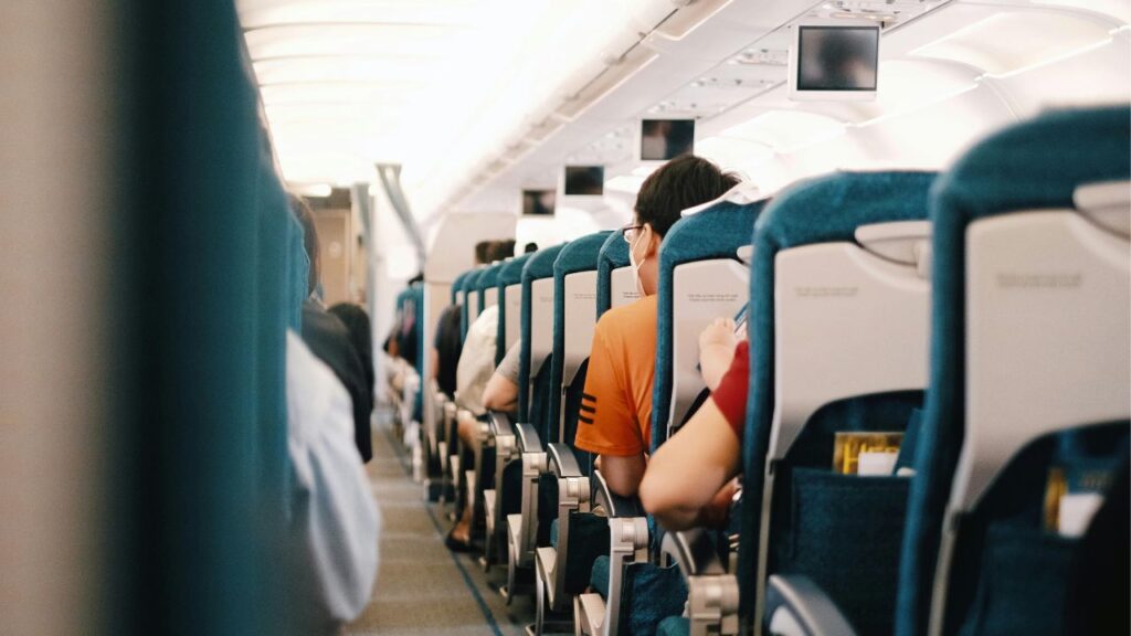 People Sitting on Blue Seats Inside an Airplane