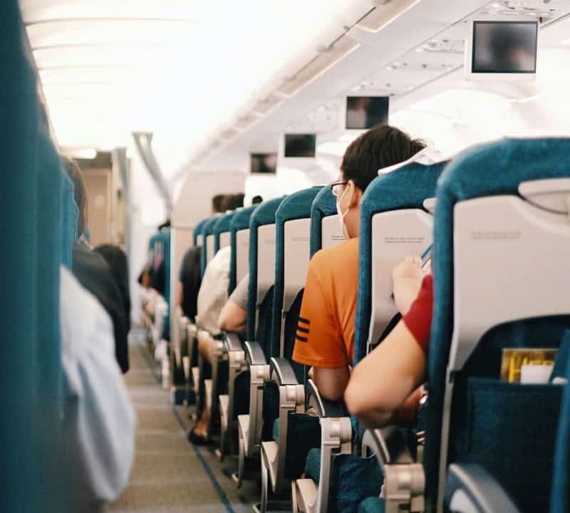 People Sitting on Blue Seats Inside an Airplane