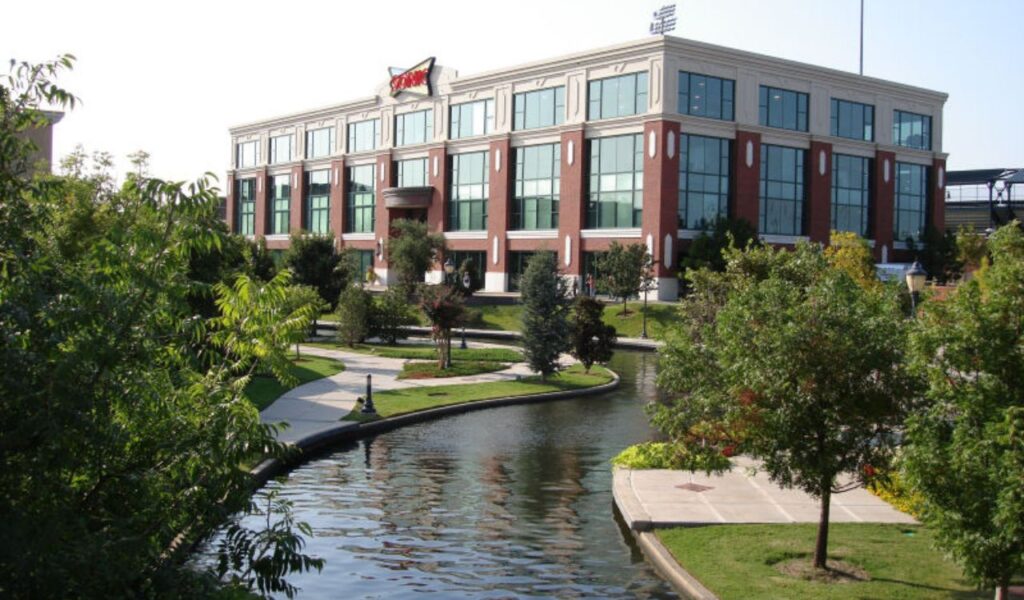 Sonic Drive-In headquarters building with canal and trees in the foreground