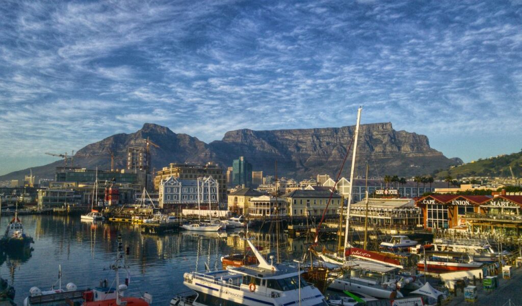 Cape Town harbor view with Table Mountain backdrop in South Africa at sunrise.