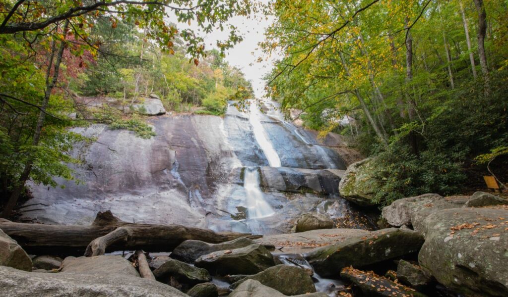 Stone Mountain waterfall flowing down smooth rock face in a forested area of North Carolina