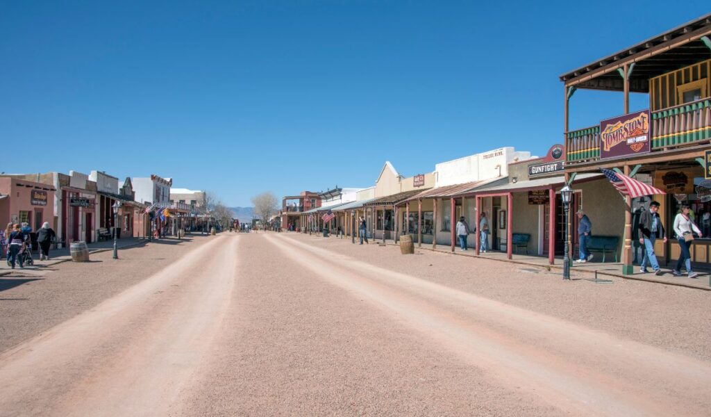 Historic main street of Tombstone, Arizona with Old West-style buildings and tourists walking