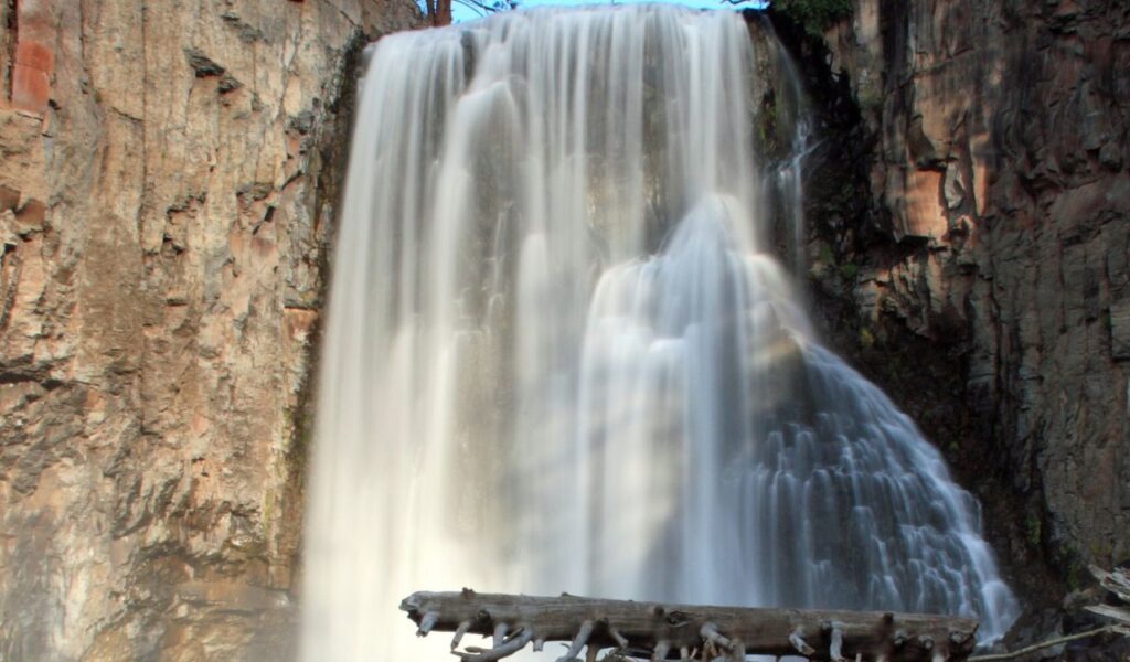 Turtleback Falls plunging into a rocky gorge surrounded by steep cliffs in North Carolina