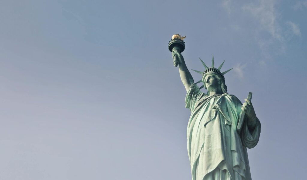 Statue of Liberty with clear sky in New York City, symbol of freedom.