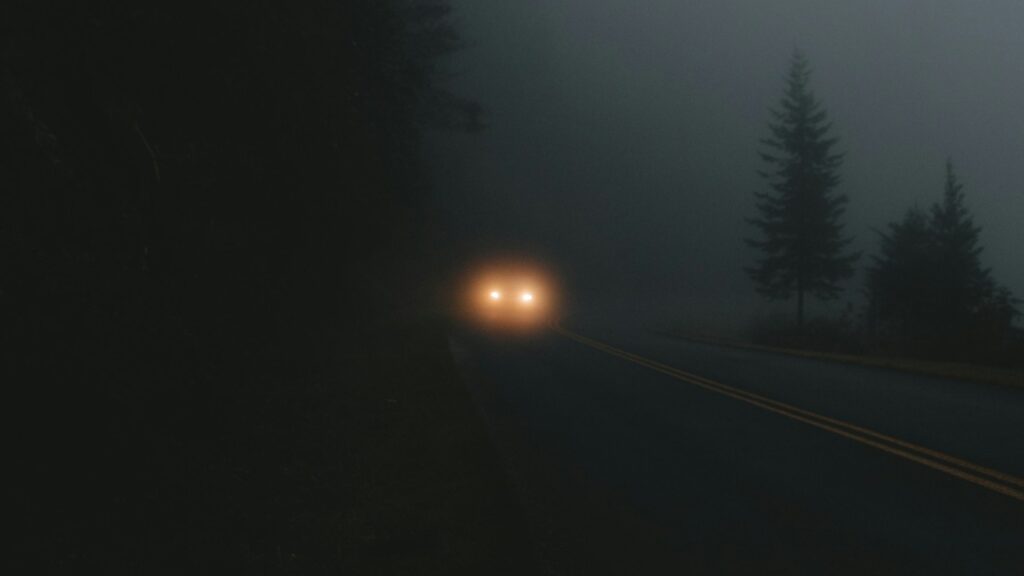 Car headlights dark mountain road