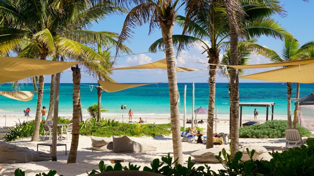 Xpu Ha Beach, Mexico - Nov. 2022: Warm turquoise waters of the Caribbean Sea wash up on the white sand beaches of the Xpu Ha seaside resorts in the Mayan Riviera region of Mexico's Yucatan peninsula