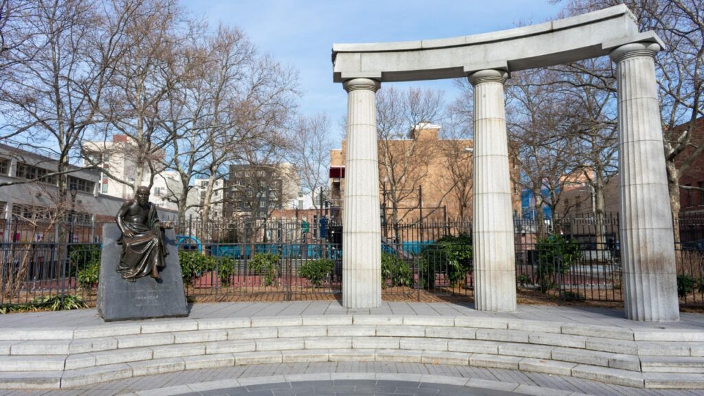 Astoria Queens, New York / USA - February 15 2020: Athens Square Park with Greek Columns and Statues in Astoria Queens