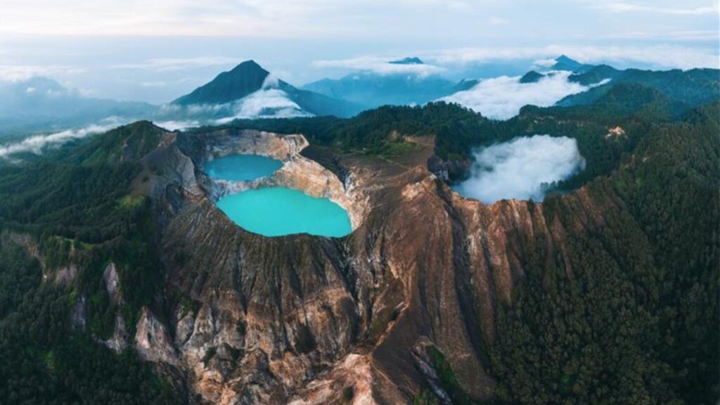 Aerial Drone view of Danau volcano Kelimutu in Ende. Sunrise. Colorful crater lake. East Nusa Tenggara Aerial view 
