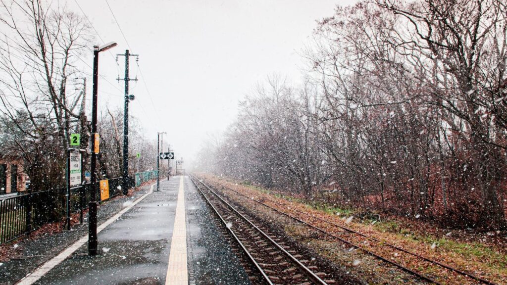 DEC 1, 2018 Hakodate, JAPAN - JR Onuma Koen station empty platform during snow fall in winter foggy atmosphere and beautiful nature scene