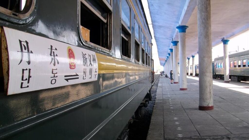 Sinuiju, North Korea - AUG 2012: The international train from Sinuiju to Dandong, China is docked at the platform of the Sinuiju Railway Station