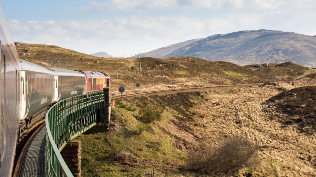 Rannoch, Scotland - May 11, 2016: The Caledonian Sleeper train crosses Rannoch Viaduct on the scenic West Highland Line railway in the Scottish Highlands