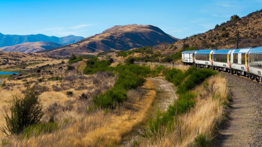 rthur’s Pass National Park, New Zealand, March 2019. KiwiRail TranzAlpine scenic train, riding among beautiful plains and mountains, popular tourist transportation on South Island