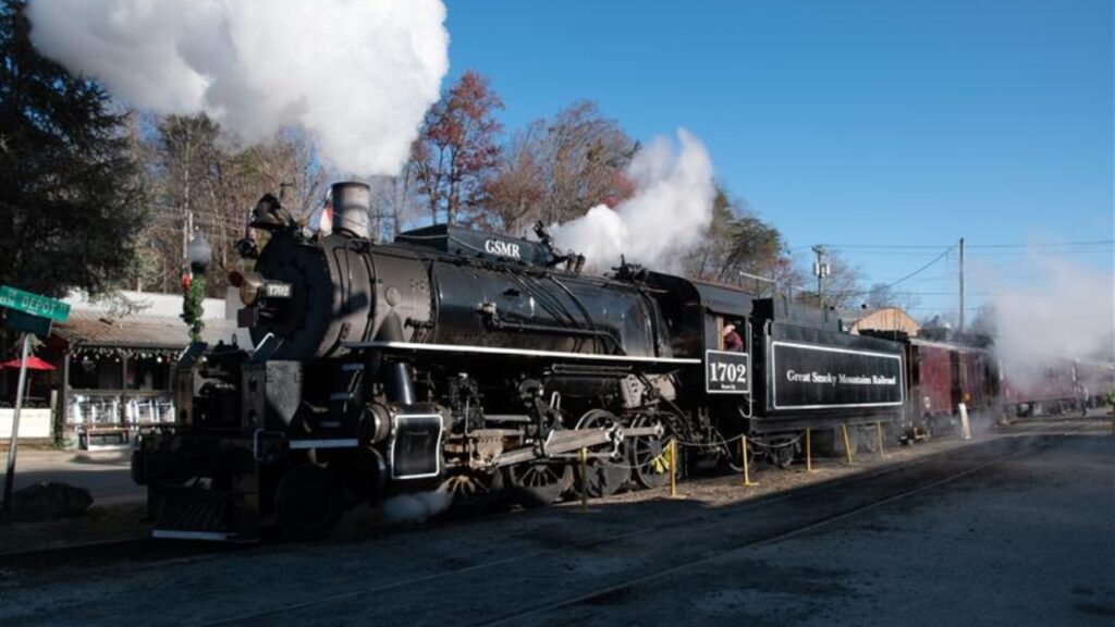 A steam powered locomotive on the train tracks in the Great Smoky Mountains