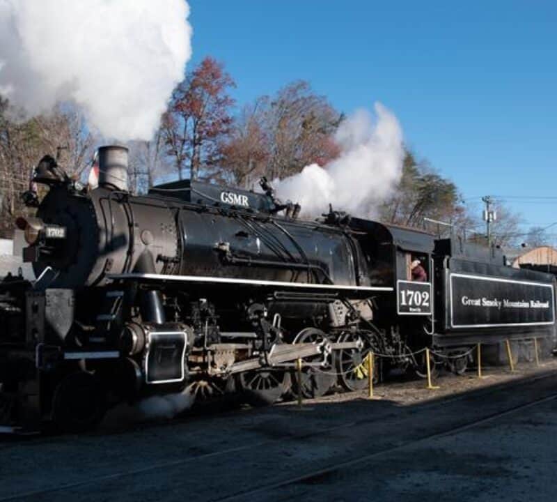 A steam powered locomotive on the train tracks in the Great Smoky Mountains