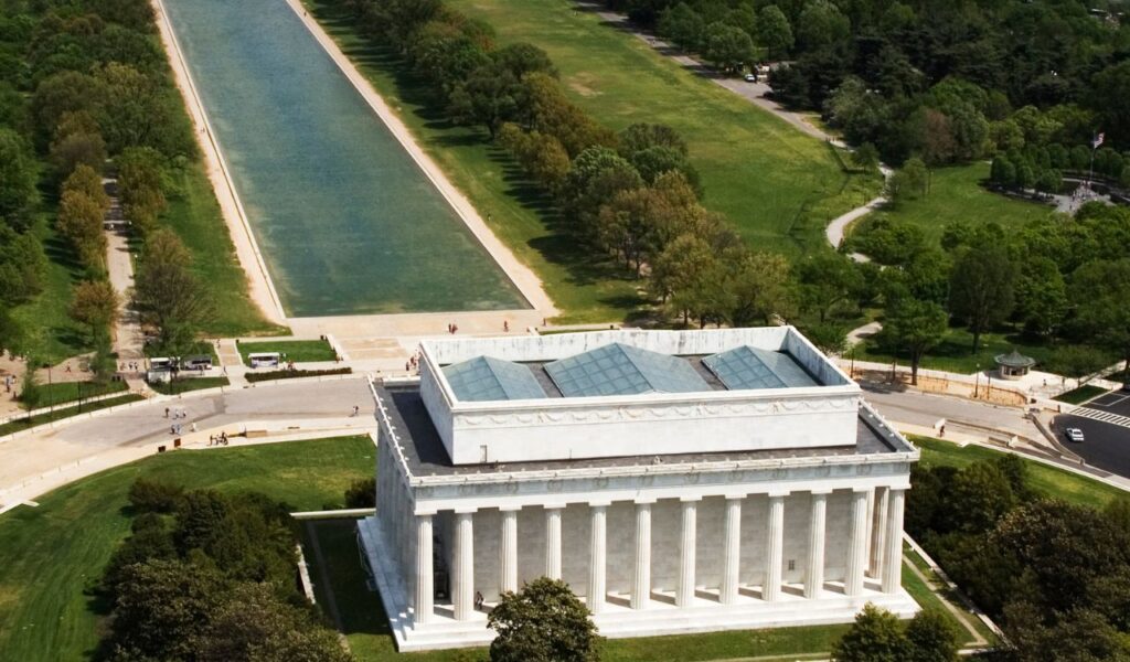 Aerial view of the Lincoln Memorial and Reflecting Pool surrounded by green trees in Washington, D.C.