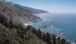 Scenic coastline and rocky shoreline at Willow Creek Beach in Big Sur with misty ocean views.
