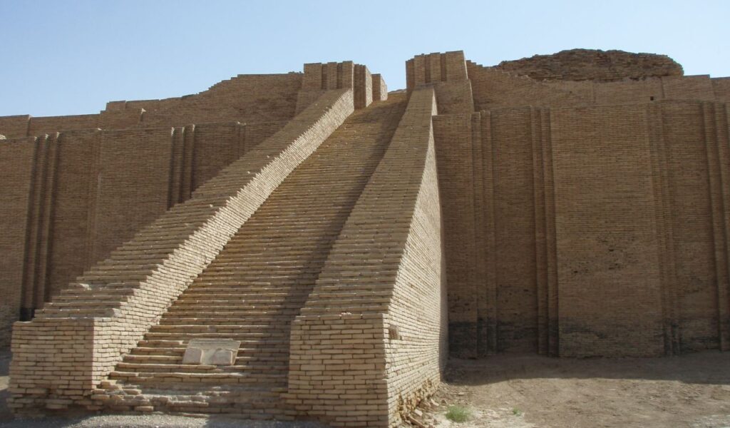Steep central staircase of the Ziggurat of Ur in Iraq, with high brick walls and restored ancient Mesopotamian structure.