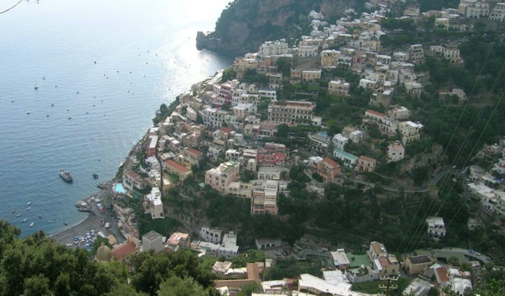 Scenic view of Positano on Italy’s Amalfi Coast with pastel-colored cliffside houses overlooking the Mediterranean Sea.