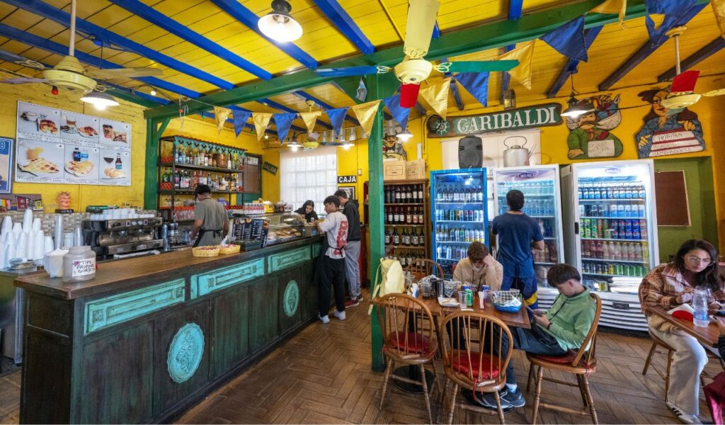Colorful Mexican café interior with vintage decor and locals enjoying snacks—ideal for casual and cozy date night vibes.