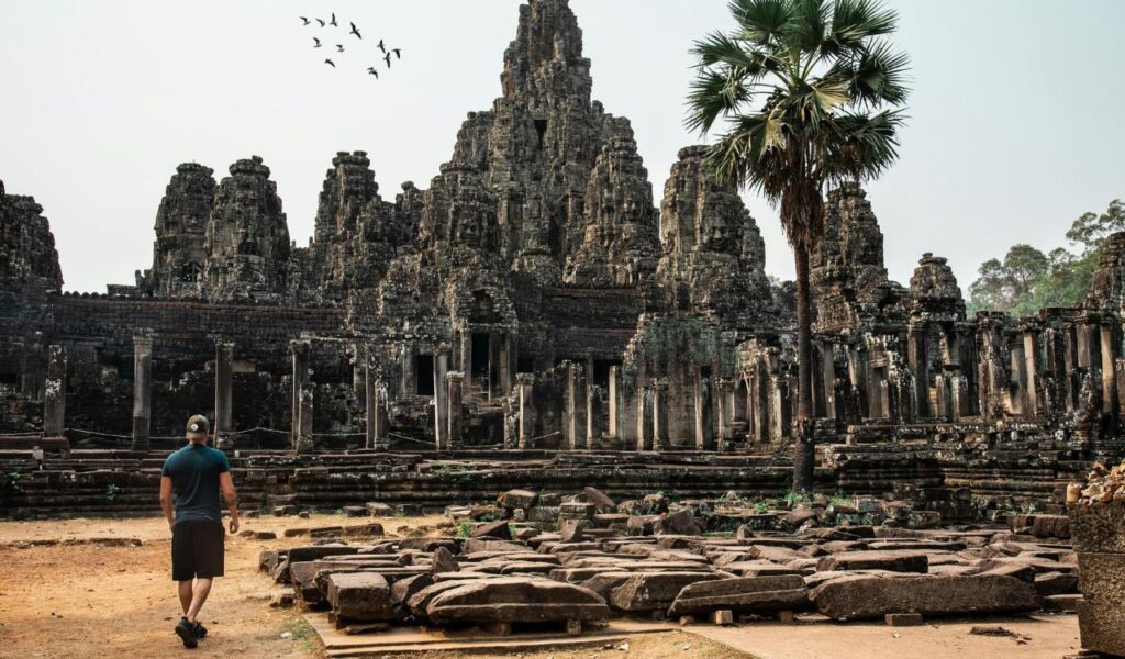 Solo traveler exploring ancient temple ruins at Angkor Wat in Cambodia.
