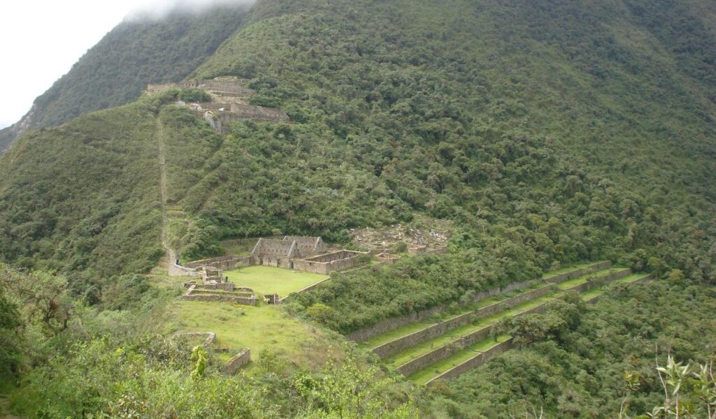 Ancient Incan ruins of Choquequirao surrounded by lush green mountains in Peru.