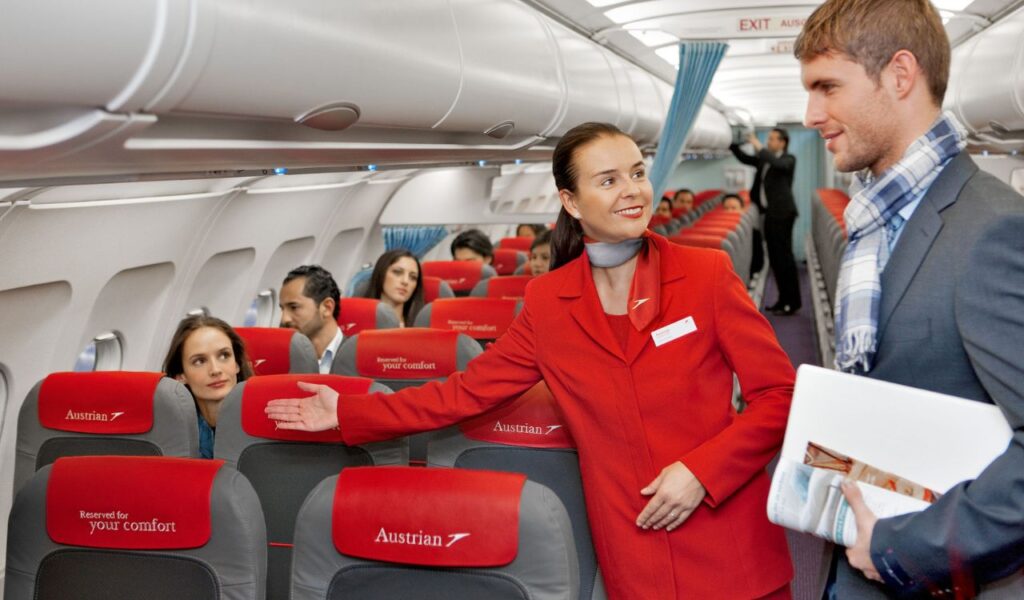 Passengers wearing smart, comfortable clothing are welcomed by a flight attendant—highlighting ease and style for air travel.