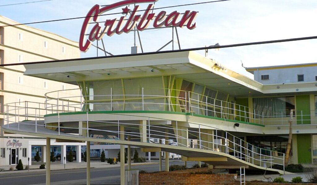 Retro-style Caribbean hotel with a distinctive sign and modern architecture, showcasing a colorful and unique design.