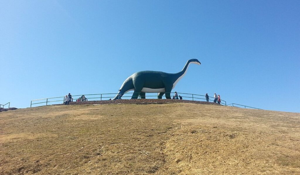 Large dinosaur statue on a hilltop along the Dinosaur Diamond Scenic Byway in Colorado.