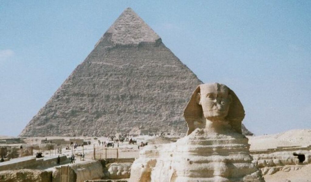 The Great Sphinx and Pyramid of Giza in Egypt under a clear blue sky, iconic symbols of ancient Egyptian history.