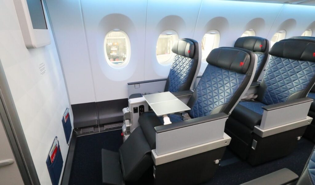 Spacious bulkhead seat with extra legroom, leg rest, tray table, and premium comfort features.