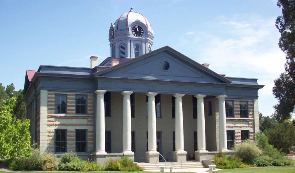 Historic Jeff Davis County Courthouse in Texas with clock tower and classical columns on a sunny day.