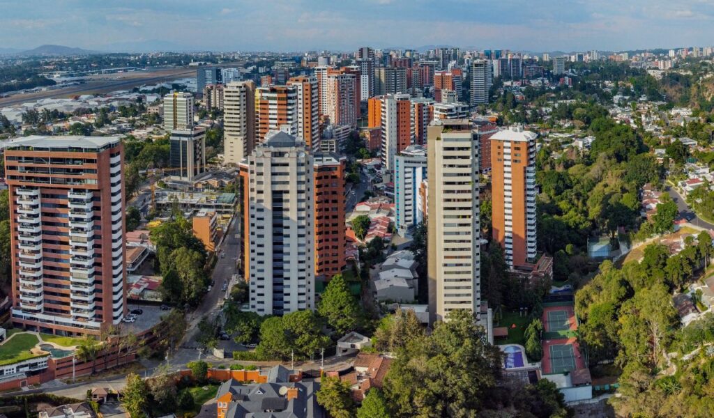 Aerial view of modern cityscape and greenery in Guatemala City, Central America.