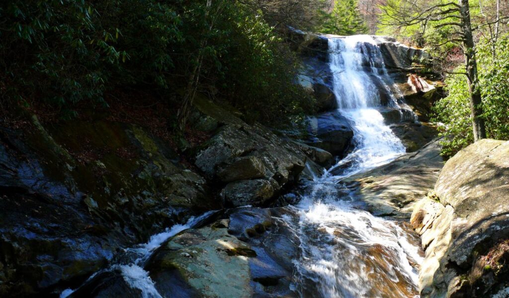 Harper Creek Falls flowing over rocks in a forest in North Carolina