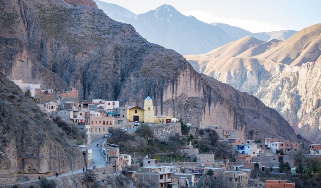 Iruya, Argentina, nestled in steep mountain cliffs with colorful buildings and scenic views.