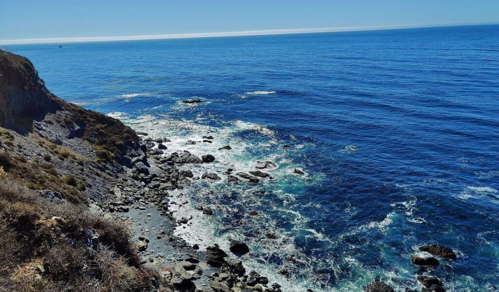 Rocky shoreline and deep blue ocean at Jade Cove, Big Sur.