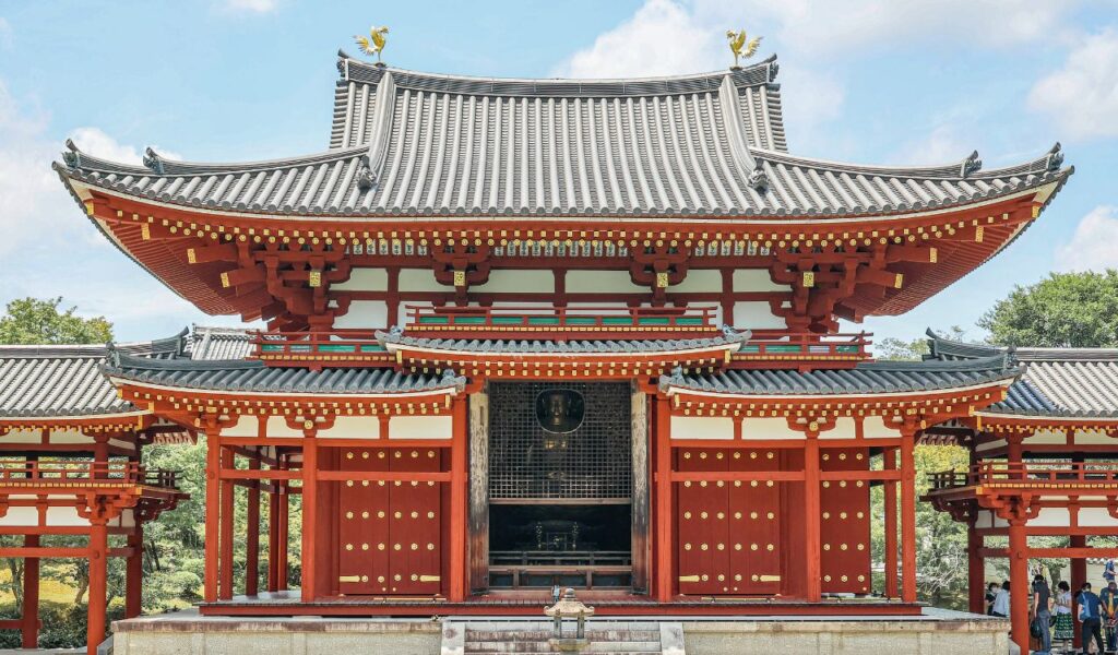 Beautiful traditional Japanese temple with intricate wooden architecture, red pillars, and detailed tiled roofing.