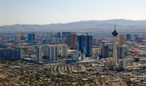 Aerial view of Las Vegas skyline with the Stratosphere Tower and surrounding cityscape in daylight.