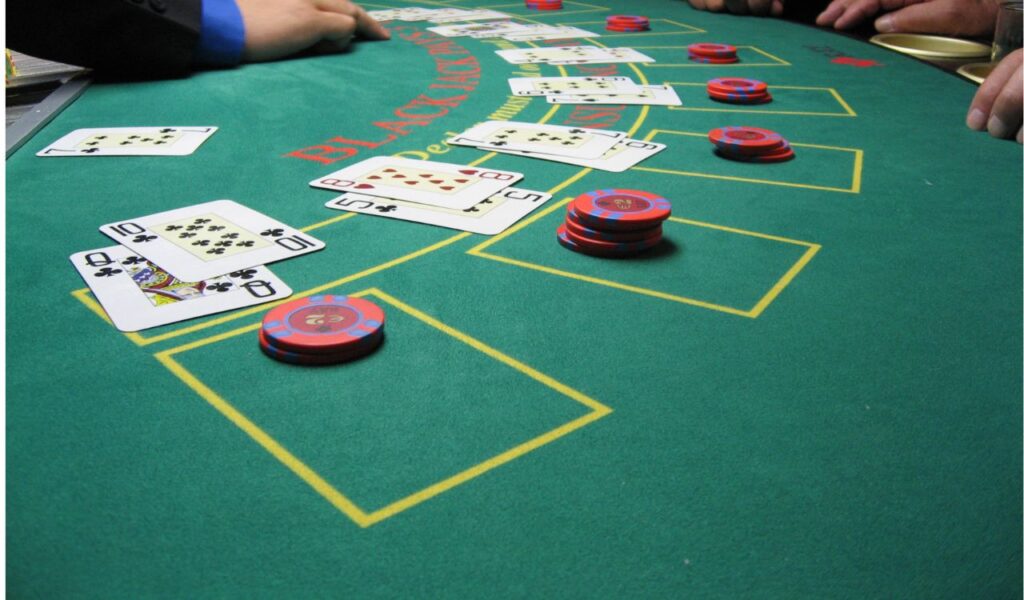 Casino blackjack table with chips and cards, symbolizing missed perks by not using a player’s card.