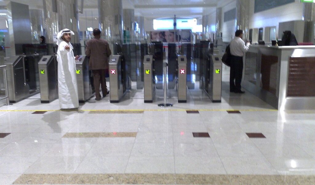 People going through airport security gates, showcasing the importance of keeping travel documents organized and accessible.
