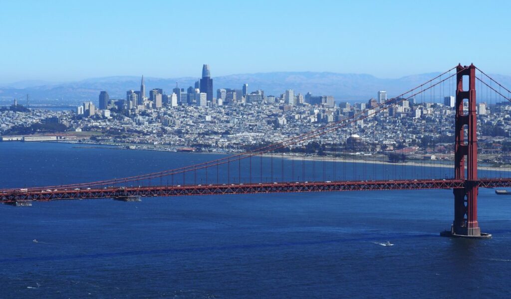 Golden Gate Bridge with San Francisco skyline in the background on a clear day.
